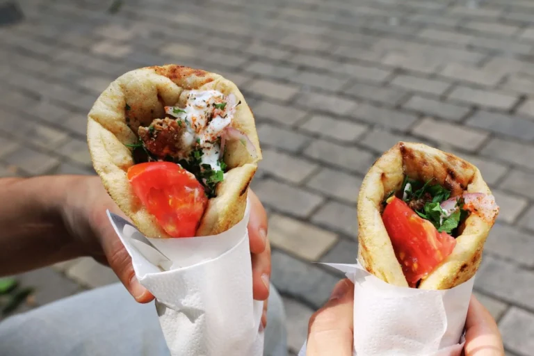 Two fresh gyros with tomato and herbs, perfect Greek street food for a sunny day.