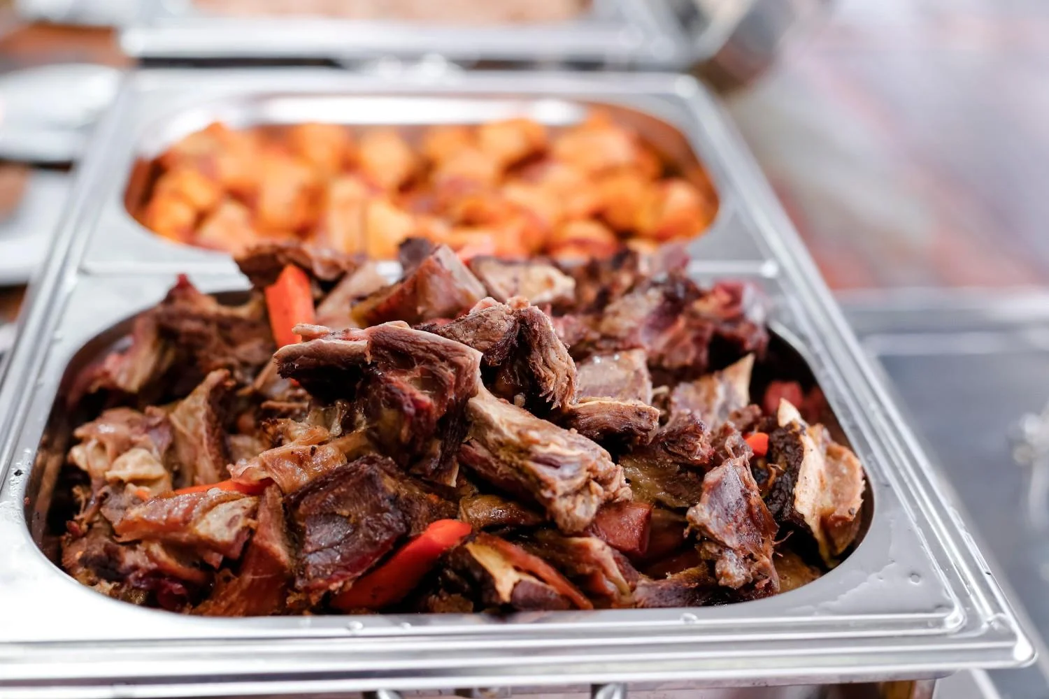 Delicious halal beef dish served in a buffet setting with roasted vegetables.