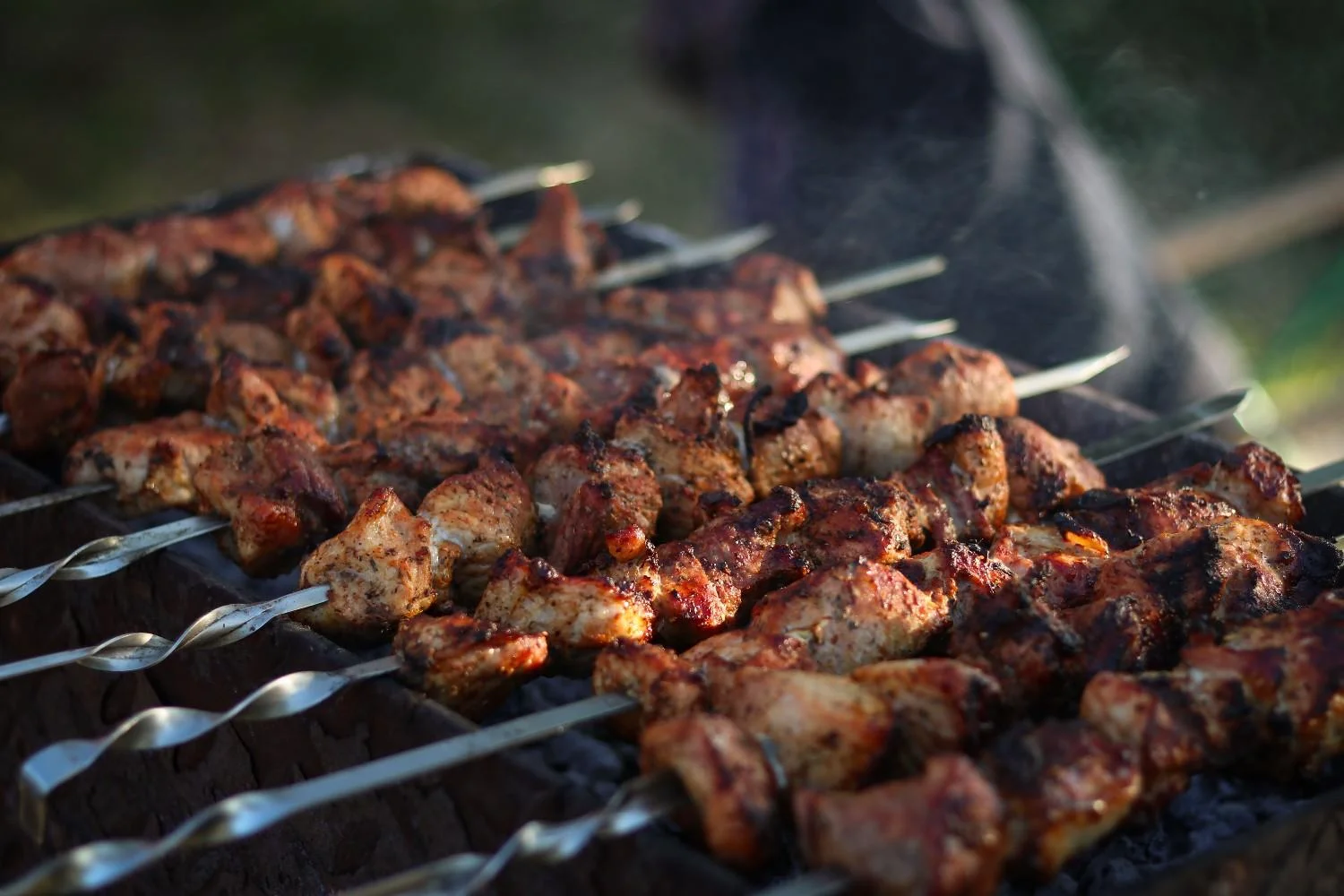Delicious Halal grilled kabobs sizzling on skewers over open flames, rich in spices and flavor