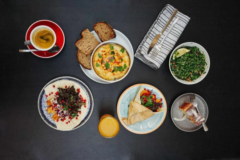 Top view of a colorful Mediterranean appetizers with, bread, hummus, and more.