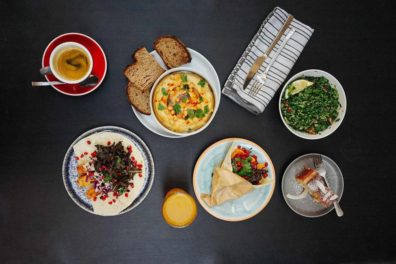 Top view of a colorful Mediterranean appetizers with, bread, hummus, and more.